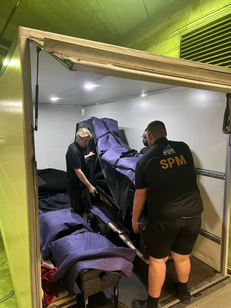 SPM crew securing a grand piano inside the specialist piano truck