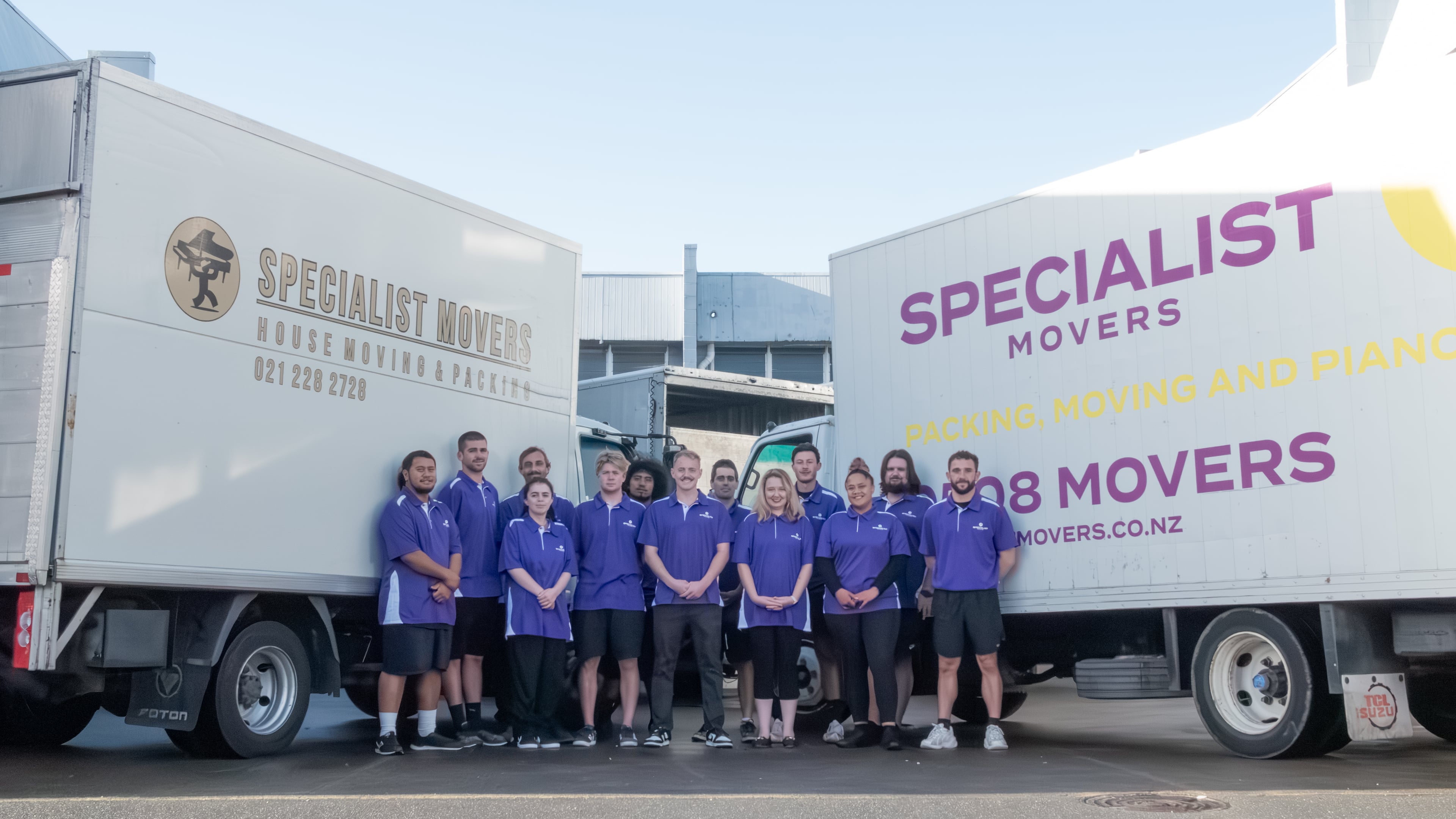 Specialist Movers team in uniform with company trucks ready for commercial work