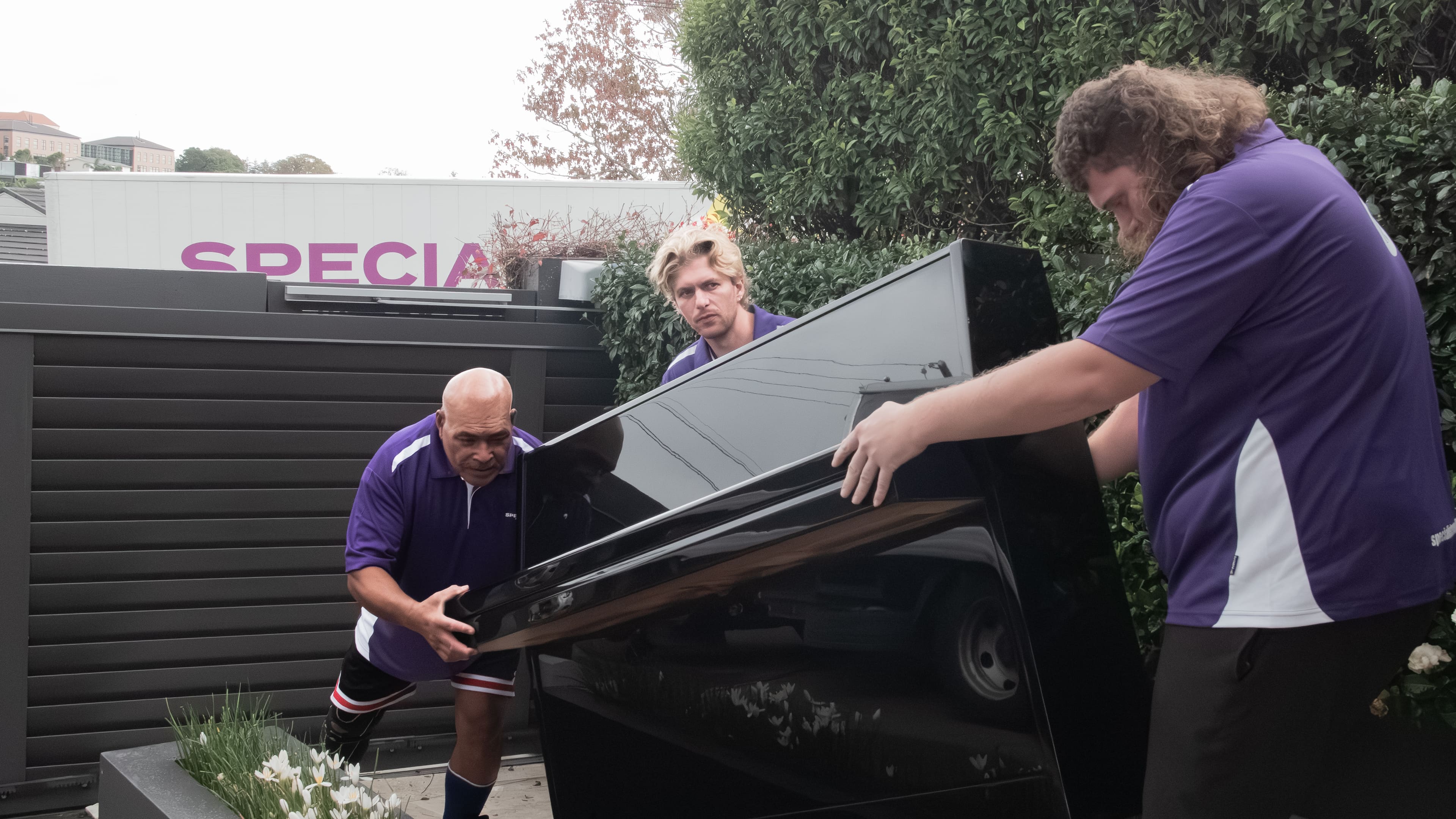 Specialist Movers crew moving a piano carefully